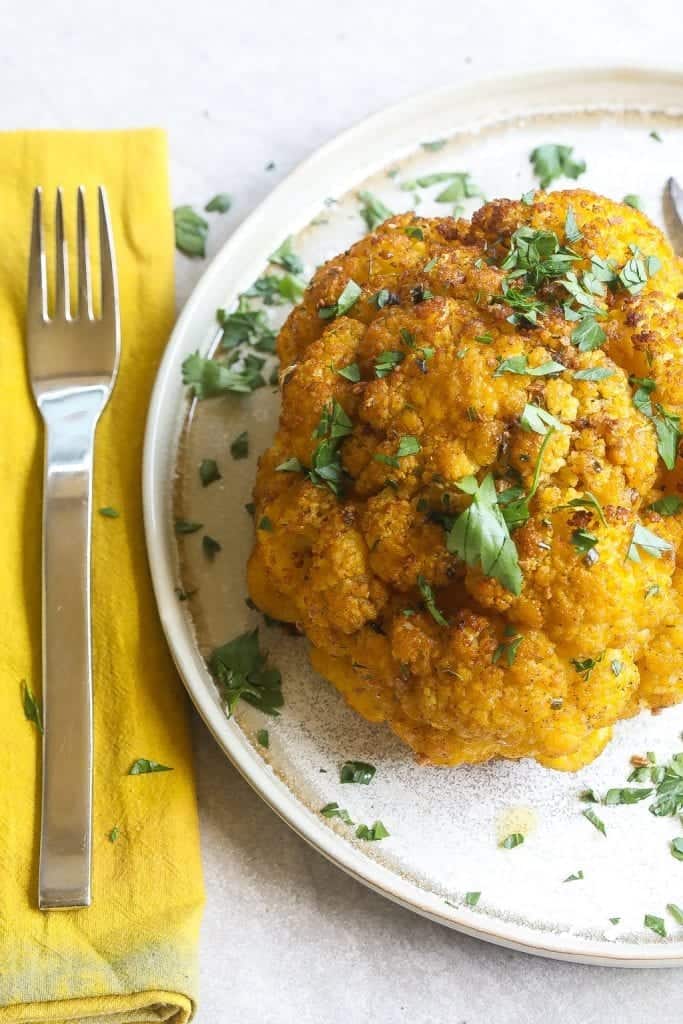 whole smoked cauliflower on a plate