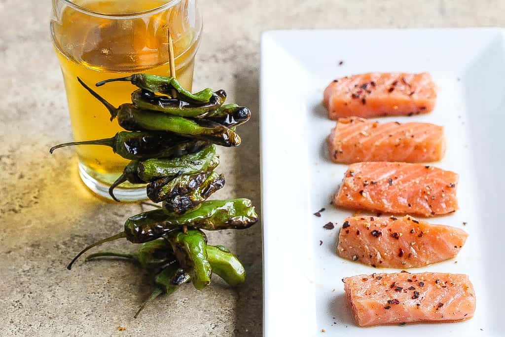 skewered shishito peppers with fresh sushi