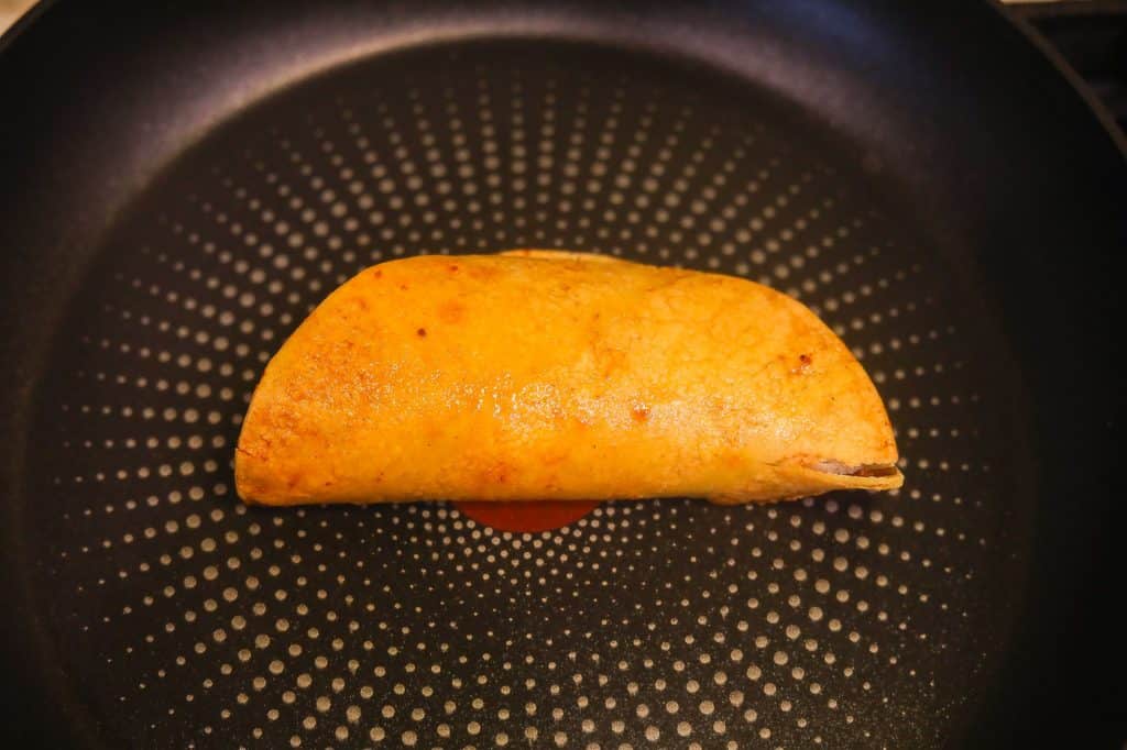 taco frying on skillet