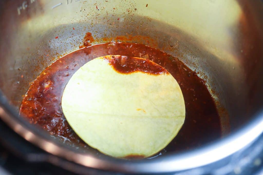 tortillas dipped in sauce