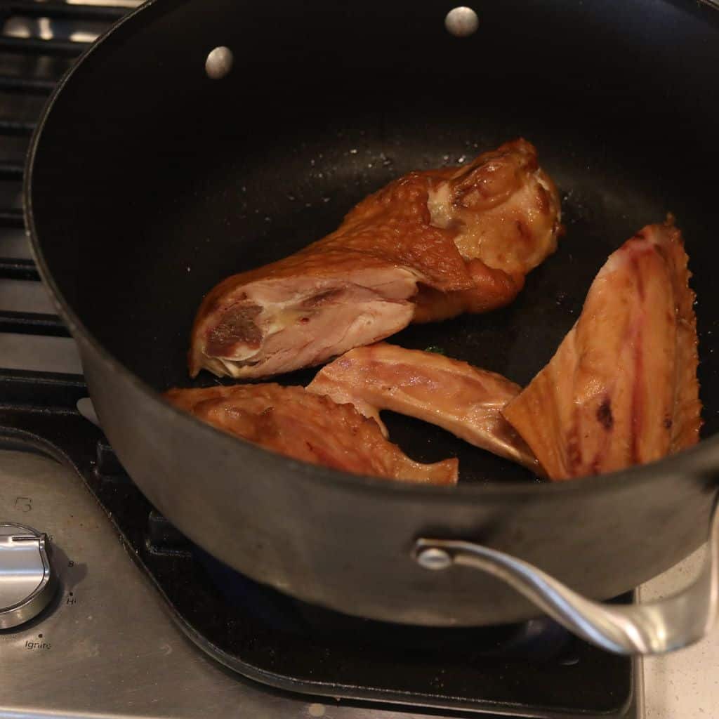 smoke turkey wings cooking in pan