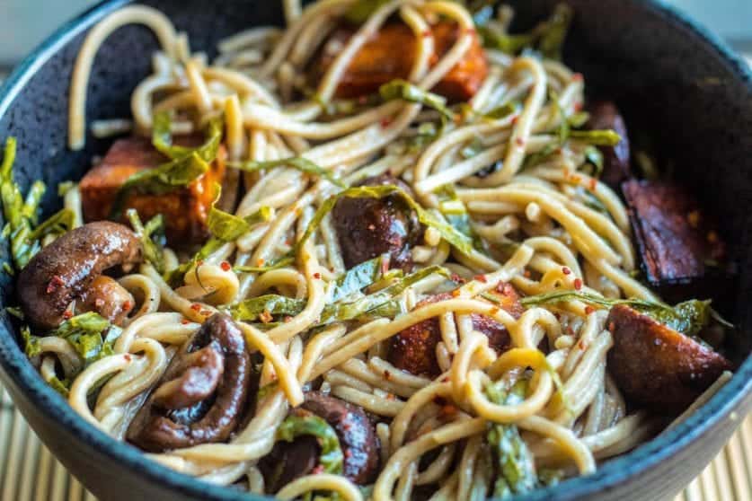 stir fried Soba Noodles bowl with roasted sweet potatoes, mushrooms, and collard greens.