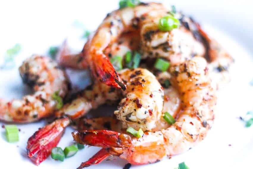 grilled piri piri shrimp on a plate with piri piri spices
