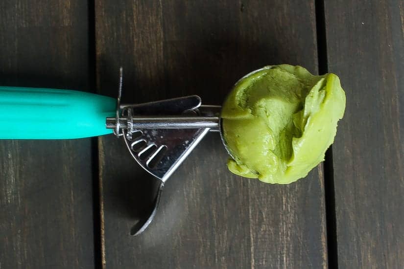 basil avocado ice cream scoops in a bowl of pomegranate sauce #icecream #avocado www.foodfidelity.com