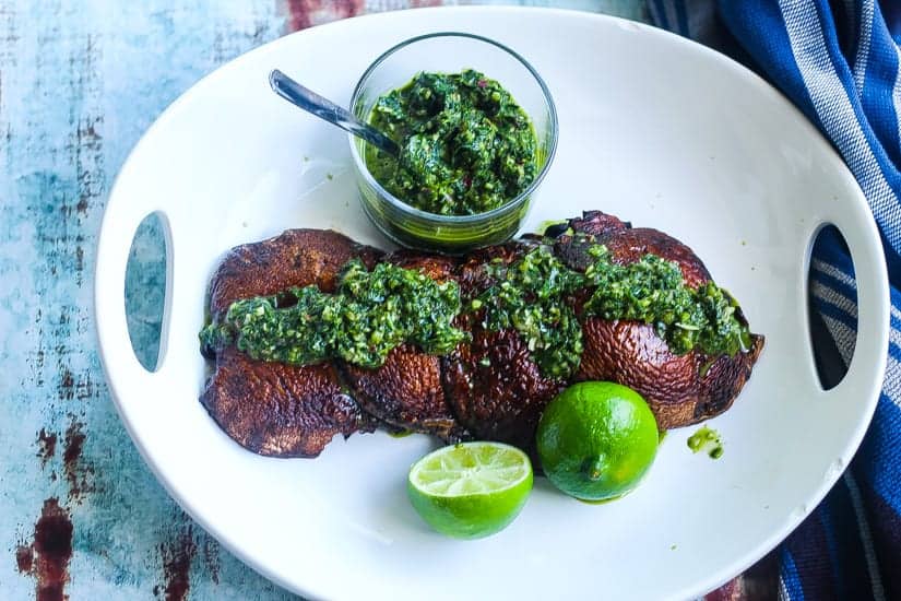 grilled portobello mushrooms on a plate with spinach chimichurri #mushrooms #portobellos www.foodfidelity.com