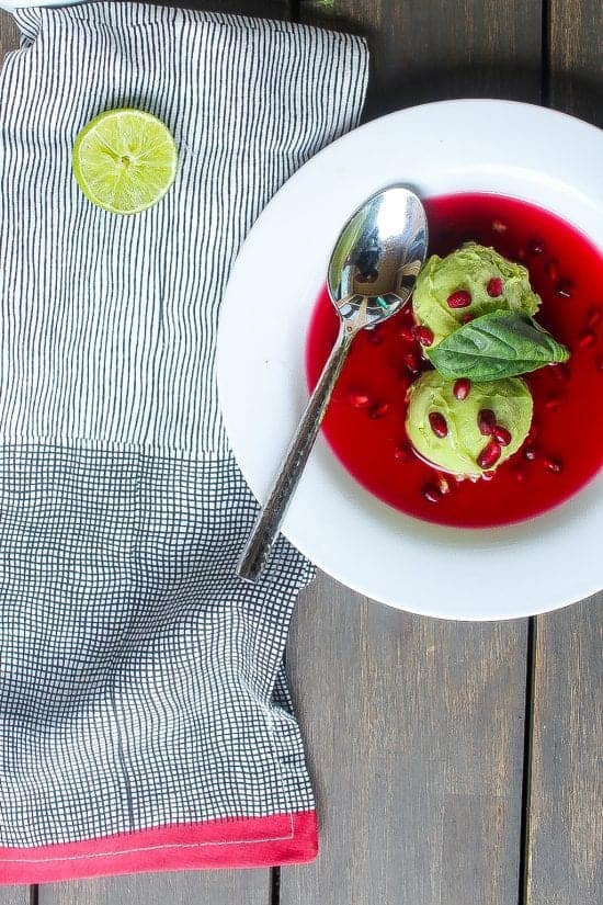 basil avocado ice cream scoops in a bowl of pomegranate sauce #icecream #avocado www.foodfidelity.com