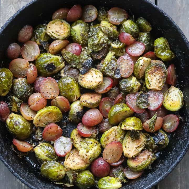roasted brussel sprouts and grapes in a skillet