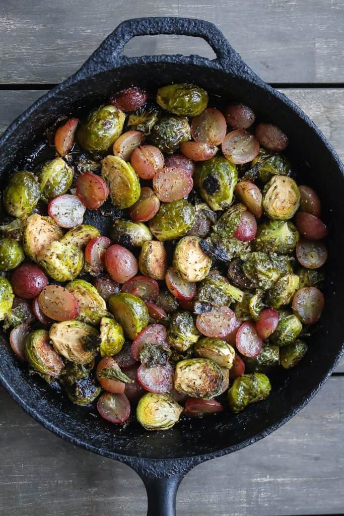 roasted brussel sprouts and grapes in a skillet