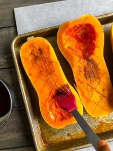 brushing oil on butternut squash half