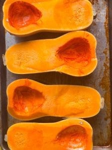 butternut sqaash halves on a tray