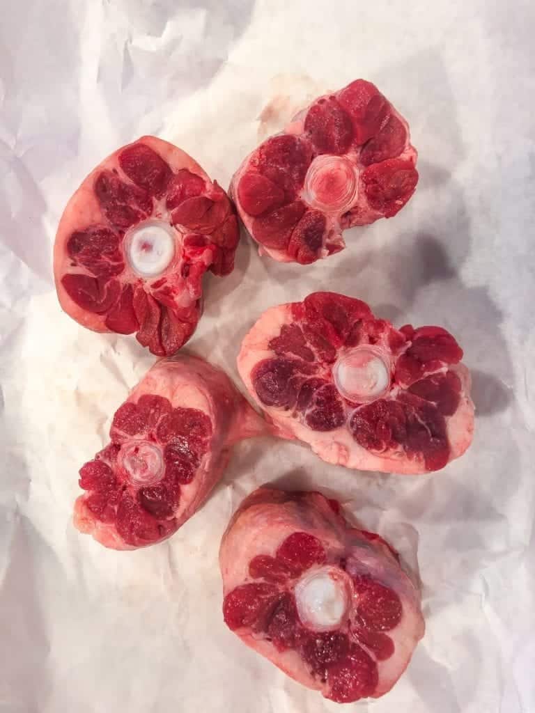 raw beef oxtails on white butcher paper