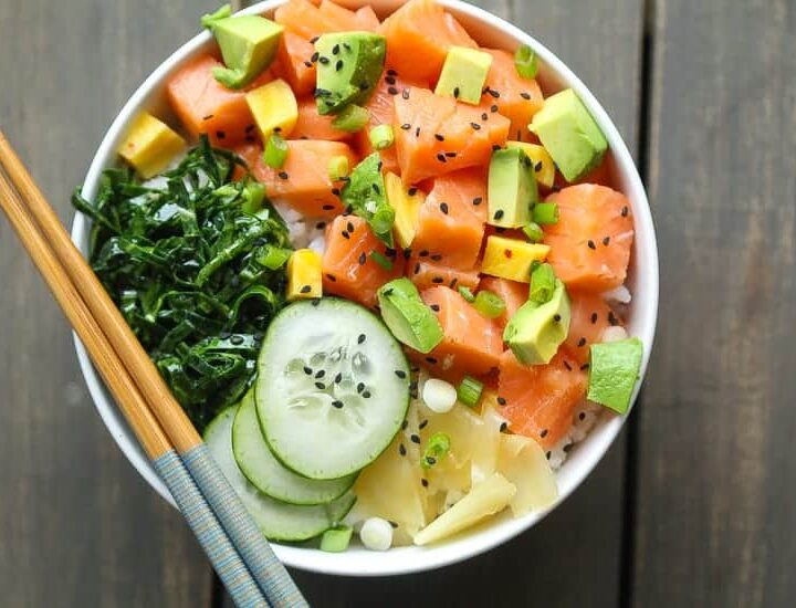 salmon poke bowl with cucumbrs, collard green salad, avocado, pickled beets and ginger