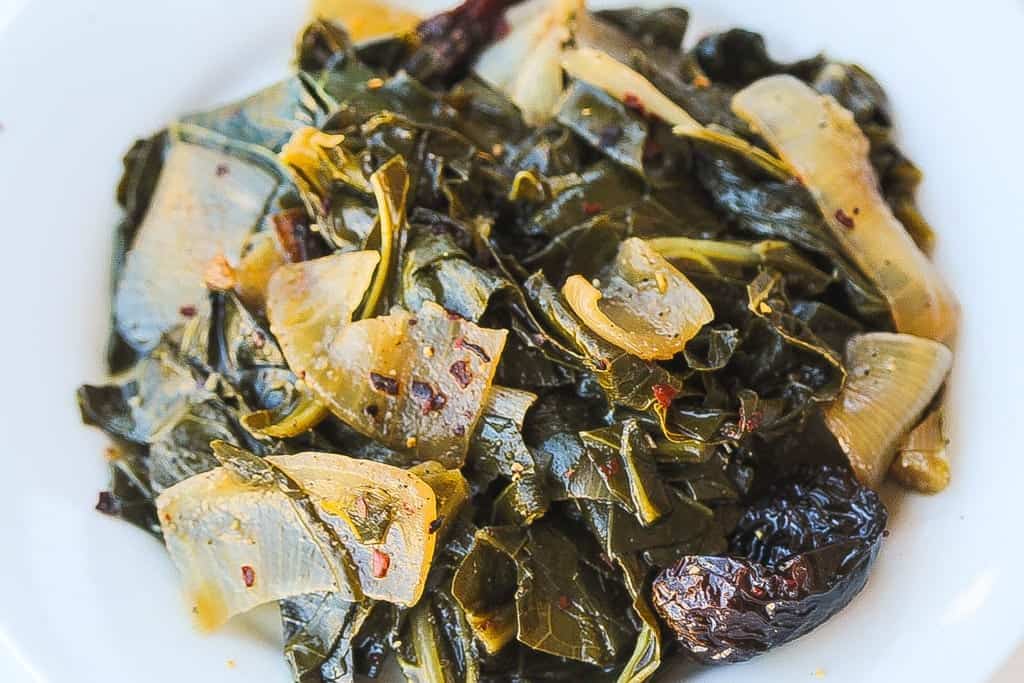 meatless wine braised collard greens with onions in a bowl