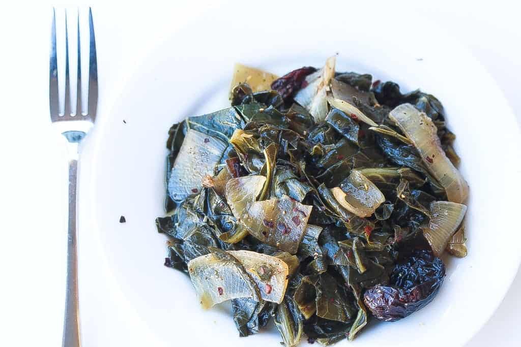 meatless wine braised collard greens with onions in a bowl