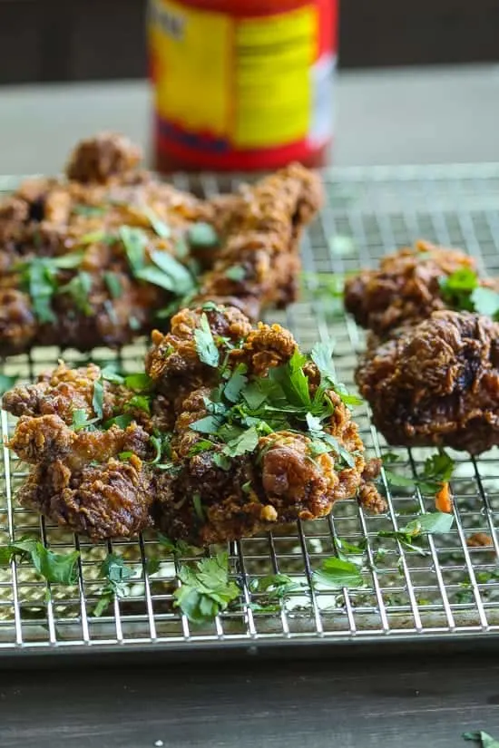 garam masala spiced fried chicken thighs on a wire rack