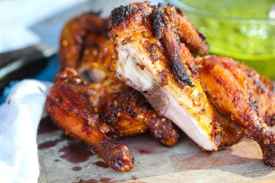 grilled piri piri chicken on cutting board