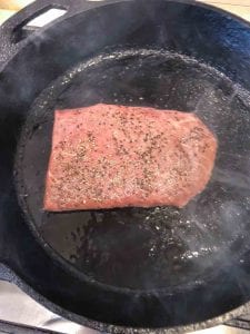 steak searing in cast iron skillet
