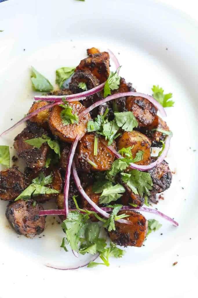 miso glazed sunchokes on a white bowl