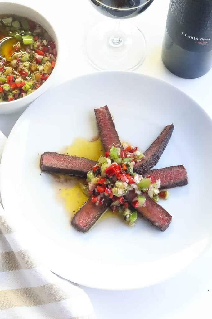 sliced flat iron steak topped with basil tomatillo sauce