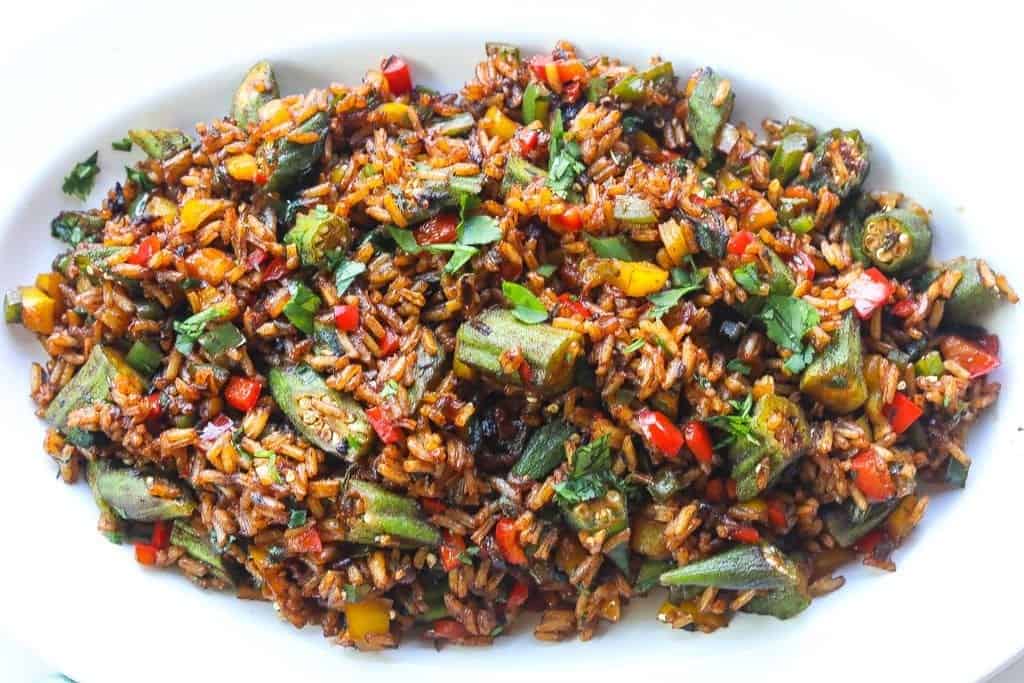 vegetable fried rice with okra on a white plate