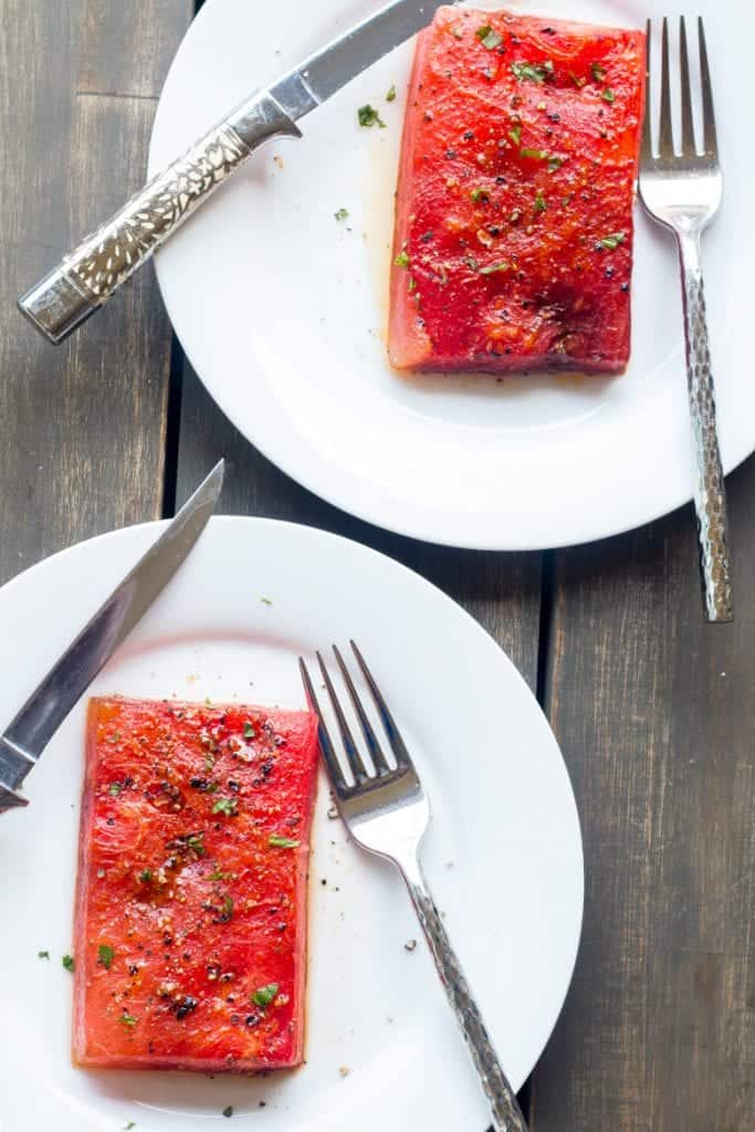 roasted watermelon steak on a plate.