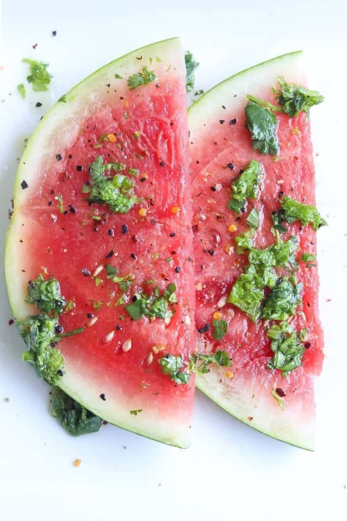 watermelon salad on a plate topped with mustard green chimichurri sauce