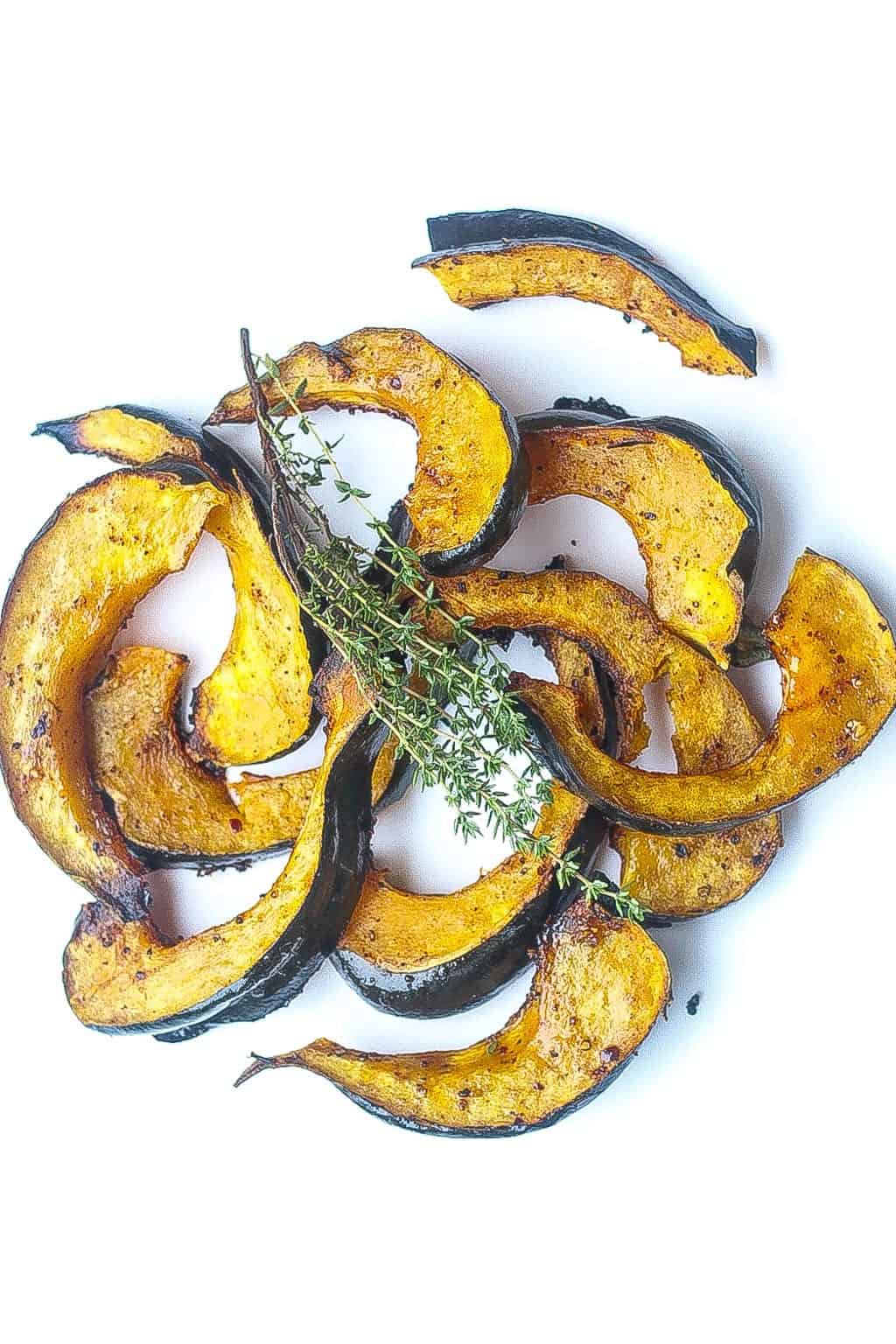 roasted acorn squash slices glazed with chili and honey topped with thyme