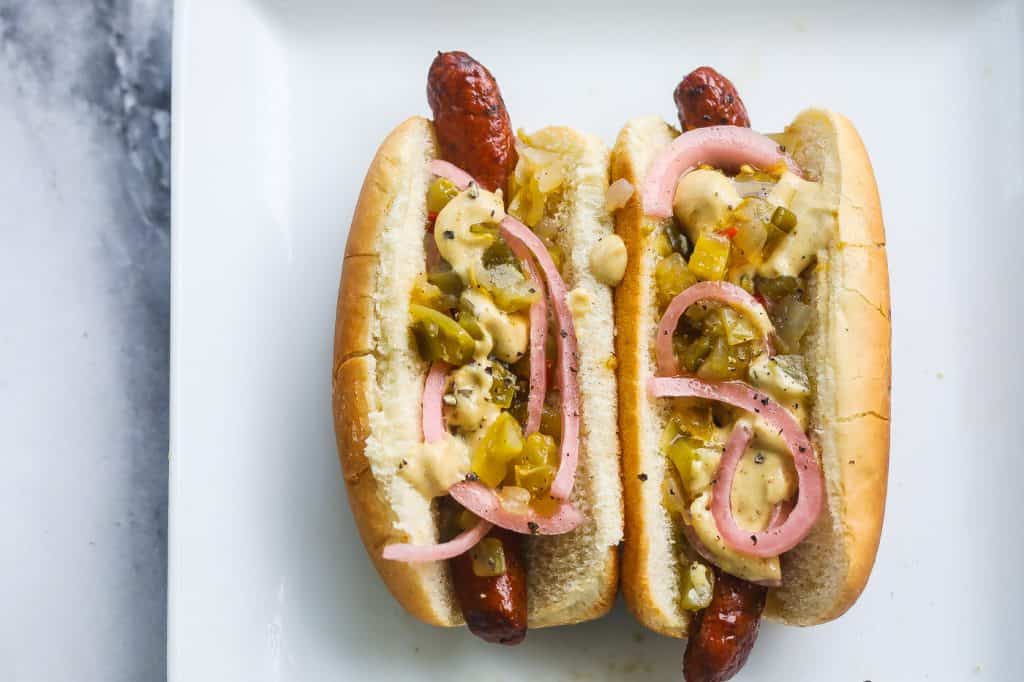 merguez sausage dogs on white plate