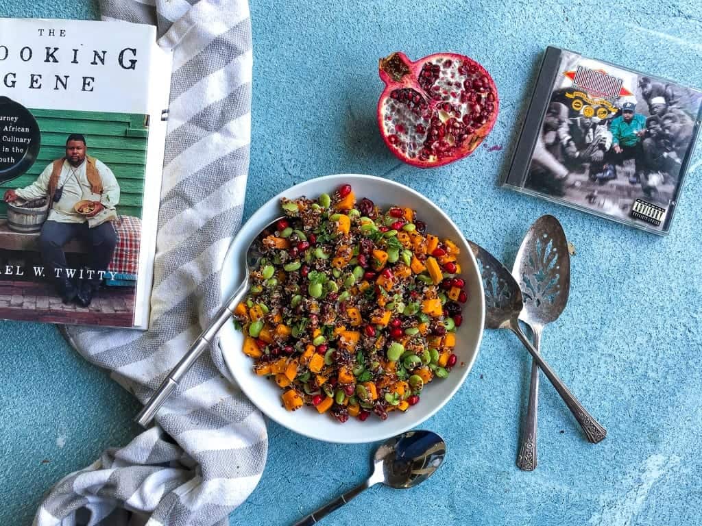 easy vegan quinoa salad with pomegrante surrounded by book and cd cover