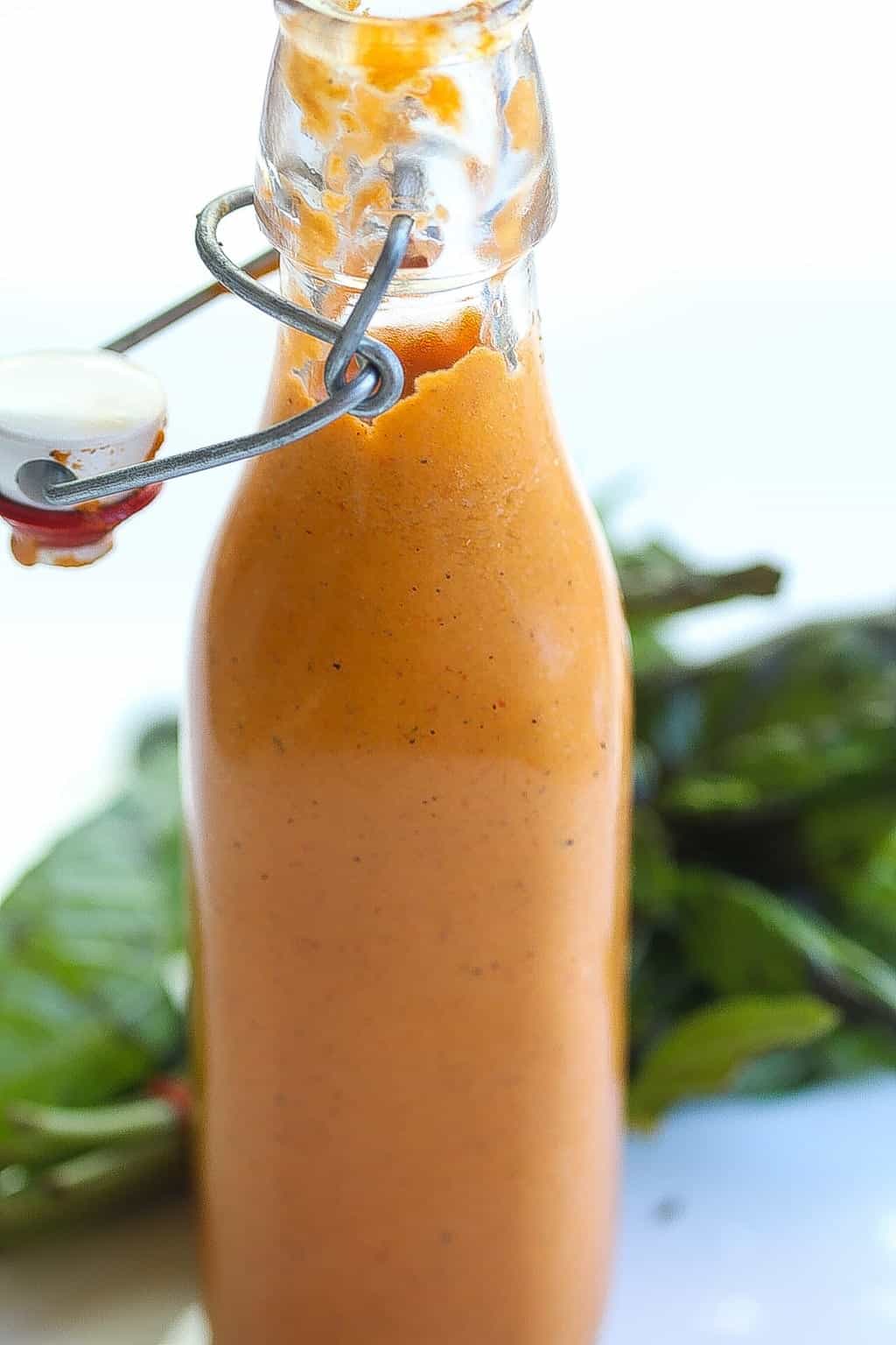 bottled roasted tight shot of red pepper sauce with basil