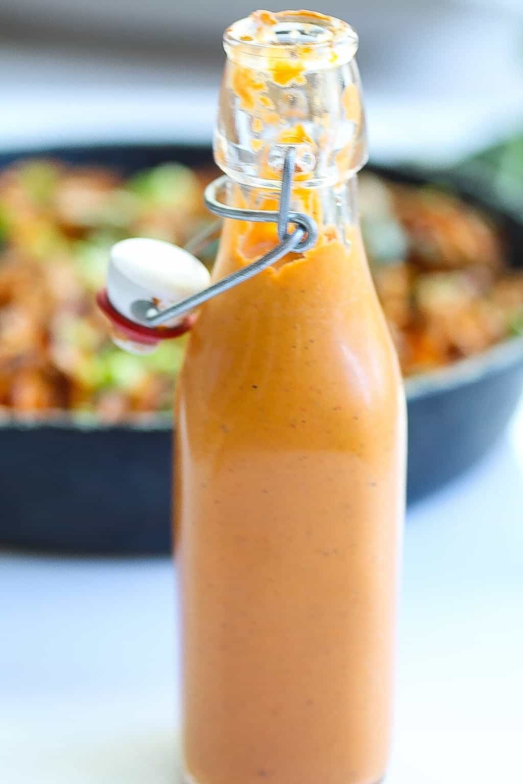 bottled roasted red pepper sauce with pan in the background