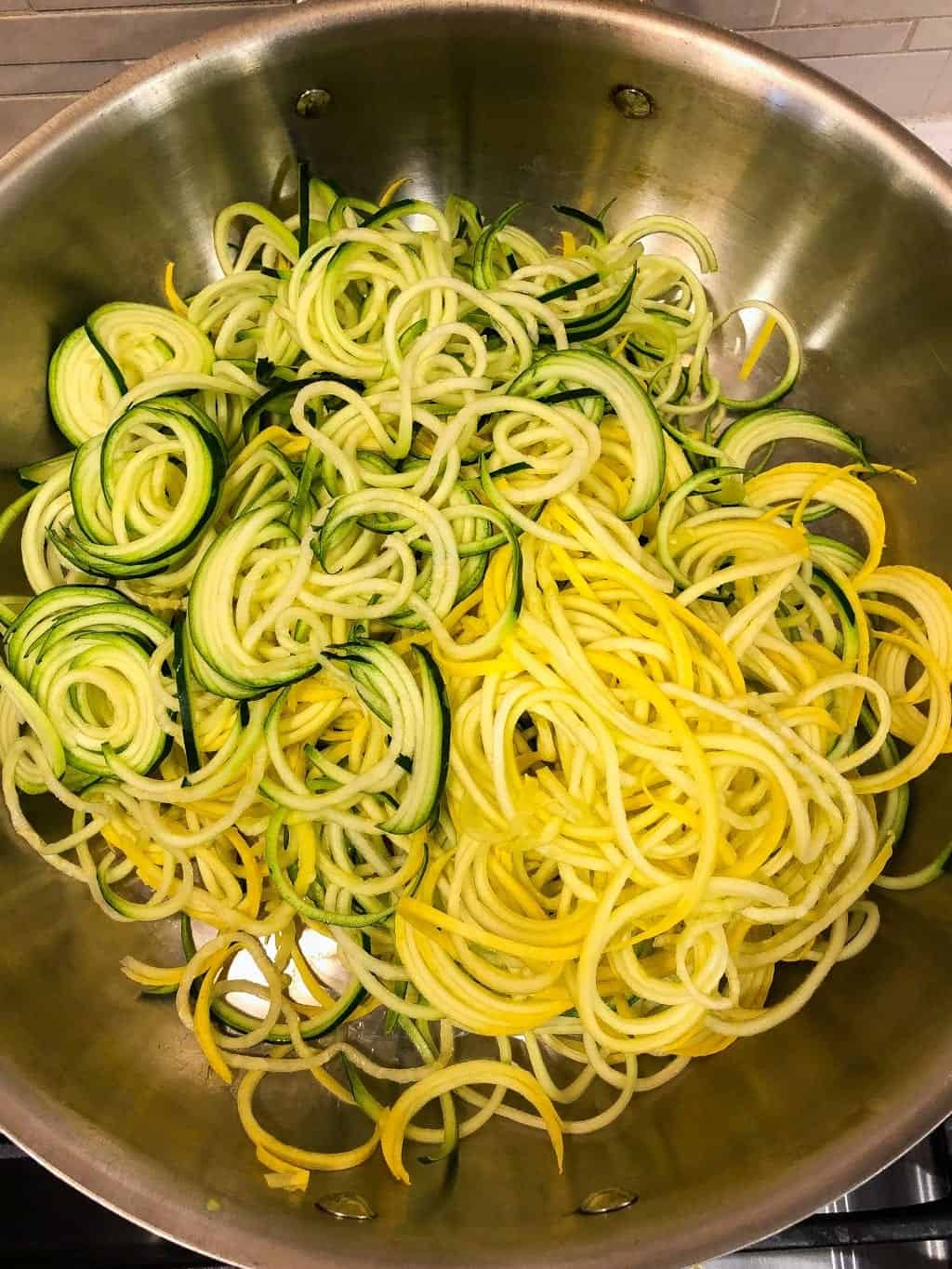 raw zucchini spirals in a pan