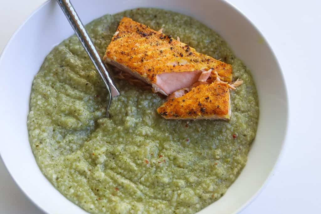 fish and grits in a bowl with tomatoes