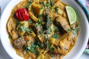 bowl of soup joumou with thyme and red scotch bonnet pepper.