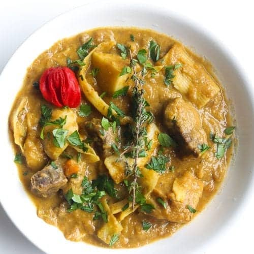 bowl of soup joumou with thyme and red scotch bonnet pepper.