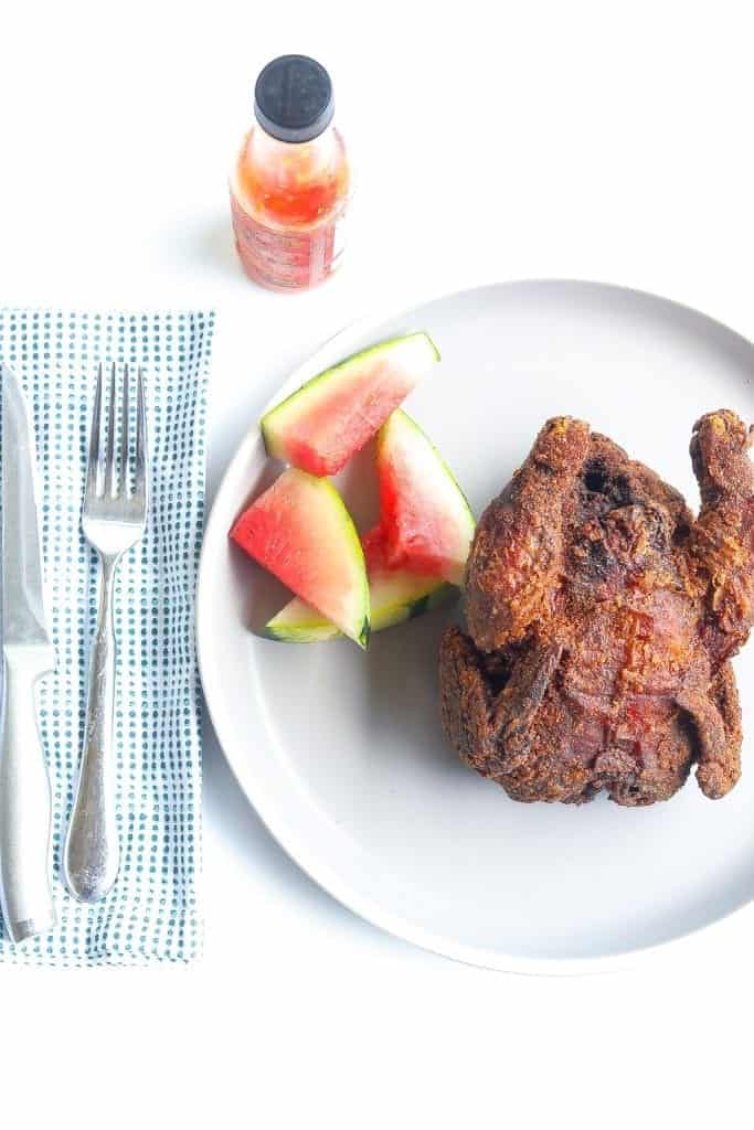 deep fried whole cornish hen on a plate