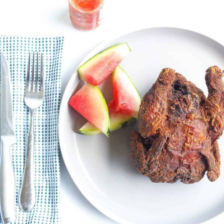 deep fried whole cornish hen on a plate