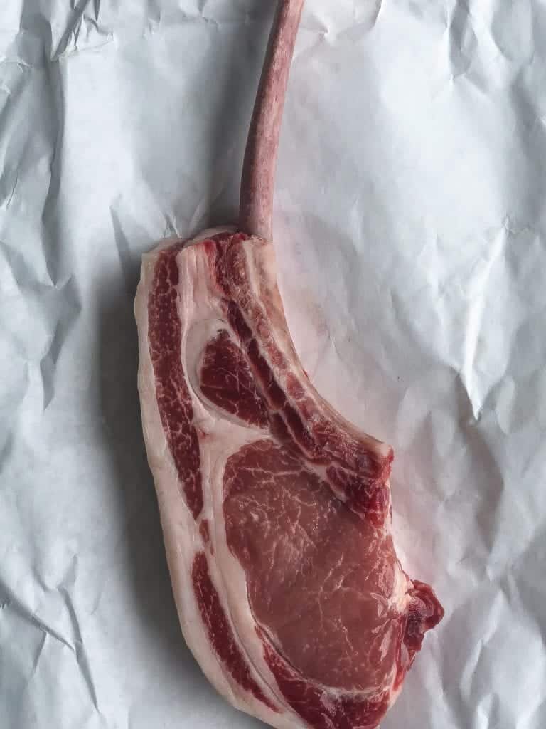 raw pork chop in butcher paper