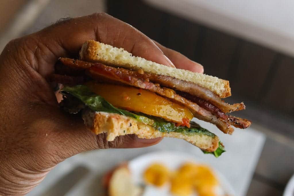 blt sandwich held in a hand