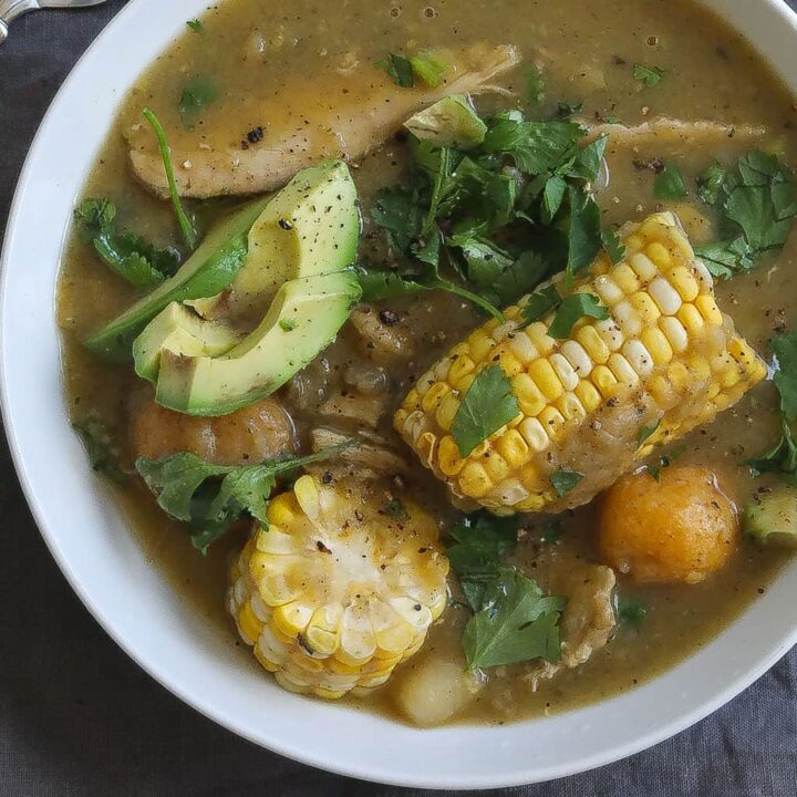 chicken and potato soup (ajiaco) with corn in a white bowl