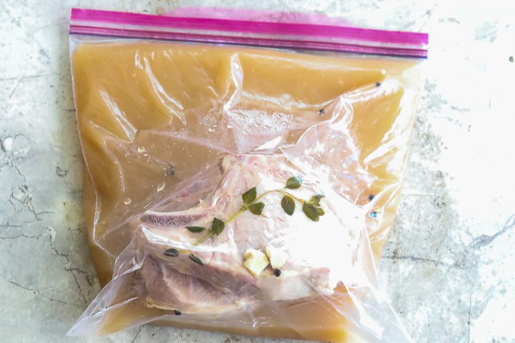 pork chops brining in a ziplock bag