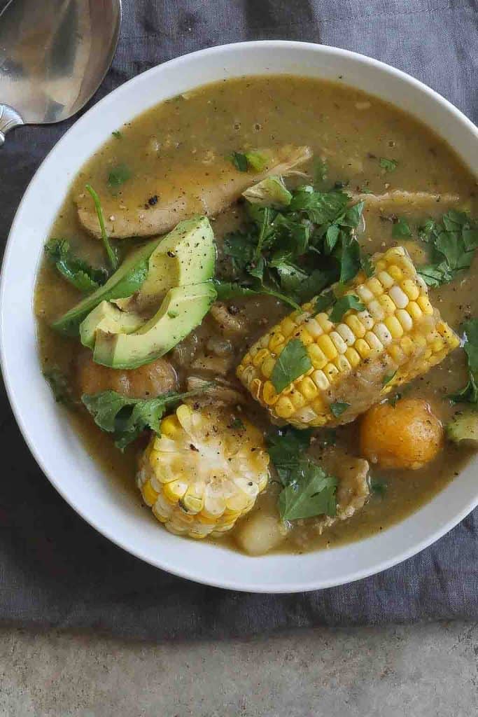 chicken and potato soup with corn in a white bowl