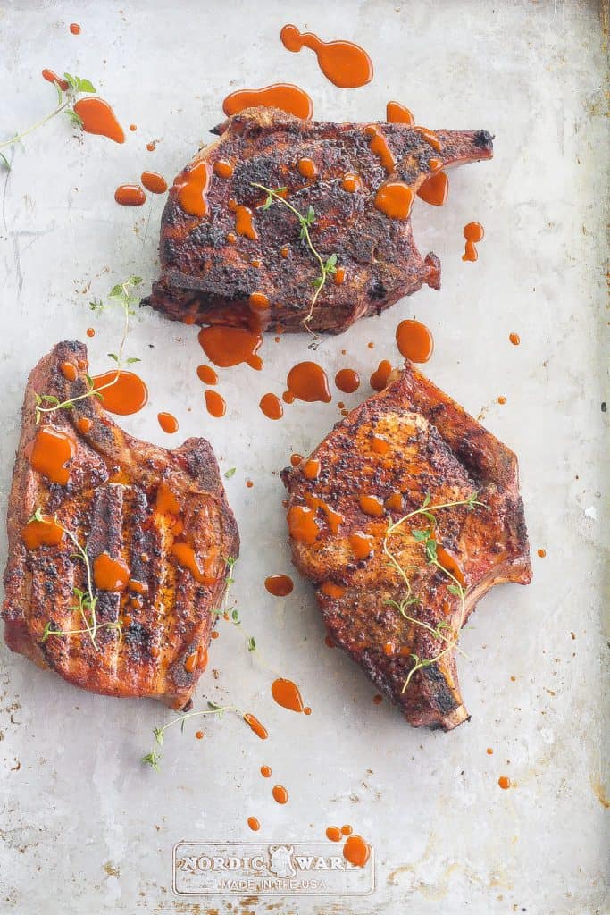 three smoked pork chops on a platter