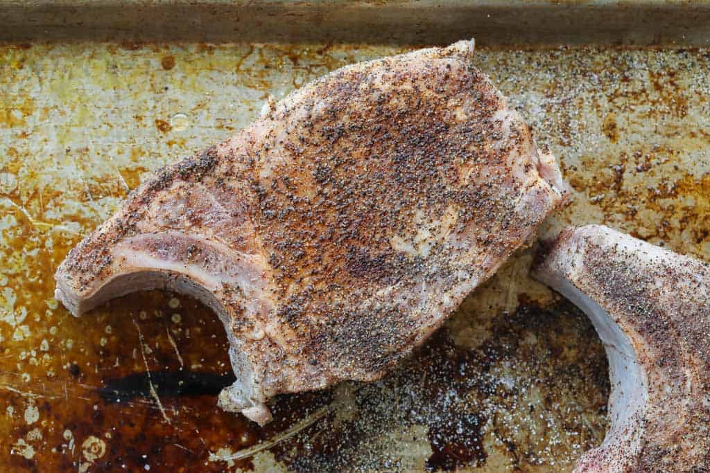 raw pork chop with seasoning