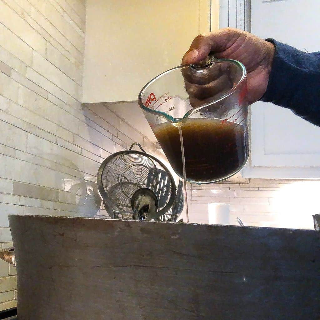 adding liquid to a pot