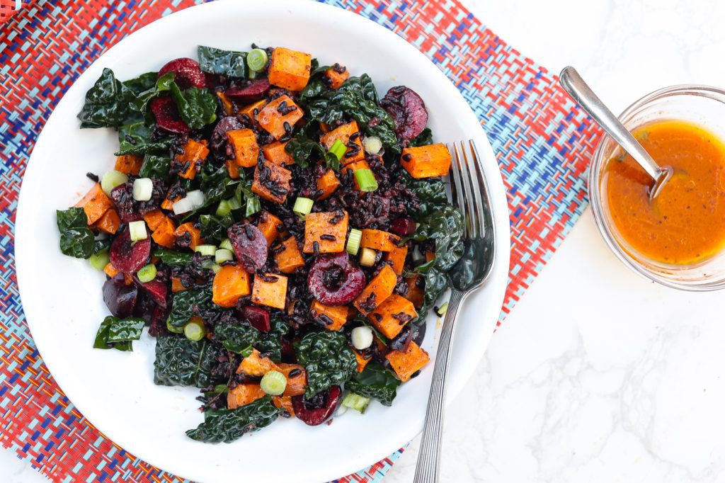 black rice salad with sweet potatoes and cherries in a bowl