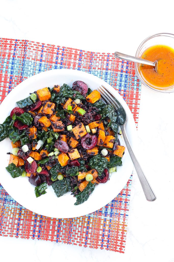 black rice salad with sweet potatoes and cherries in a bowl