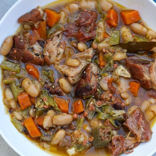 white bean stew with ham hocks in a bowl