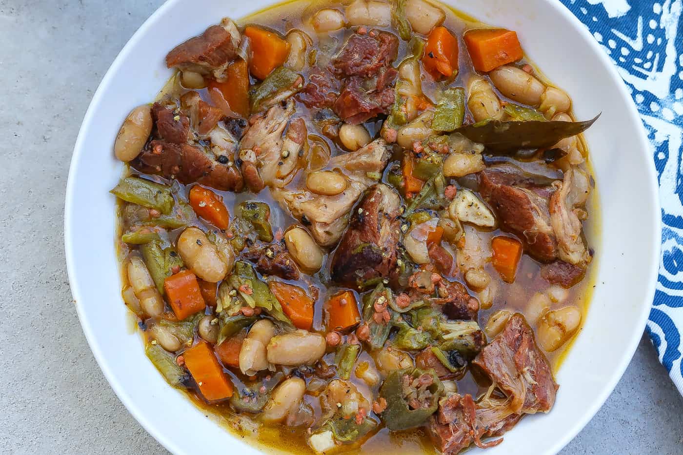 white bean stew with ham hocks in a bowl