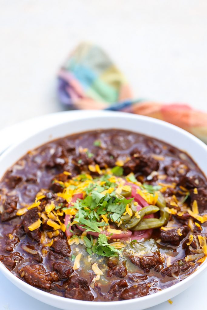 bowl of Texas chili with onions and cilantro